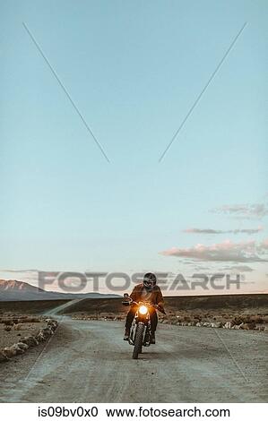 Motorcyclist riding in desert, Trona Pinnacles, California, US View Large Photo Image Stock Image - Motorcyclist riding in desert, Trona Pinnacles, California, US. Fotosearch