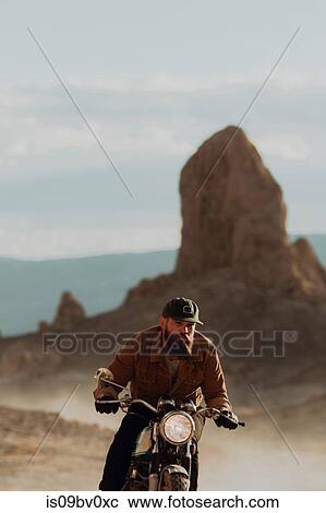 Motorcyclist riding in desert, Trona Pinnacles, California, US View Large Photo Image Stock Image - Motorcyclist riding in desert, Trona Pinnacles, California, US. Fotosearch