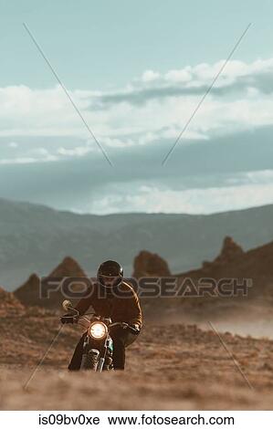 Motorcyclist riding in desert, Trona Pinnacles, California, US View Large Photo Image Stock Image - Motorcyclist riding in desert, Trona Pinnacles, California, US. Fotosearch