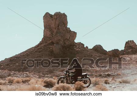 Motorcyclist riding in desert, Trona Pinnacles, California, US View Large Photo Image Stock Photo - Motorcyclist riding in desert, Trona Pinnacles, California, US. Fotosearch