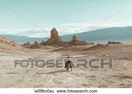 Motorcyclist riding in desert, Trona Pinnacles, California, US View Large Photo Image Stock Photograph - Motorcyclist riding in desert, Trona Pinnacles, California, US. Fotosearch