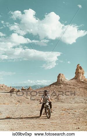 Motorcyclist riding in desert, Trona Pinnacles, California, US View Large Photo Image Stock Photography - Motorcyclist riding in desert, Trona Pinnacles, California, US. Fotosearch