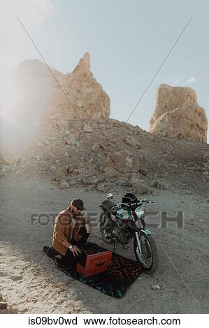 Motorcyclist with toolbox beside bike, Trona Pinnacles, California, US View Large Photo Image Stock Image - Motorcyclist with toolbox beside bike, Trona Pinnacles, California, US. Fotosearch