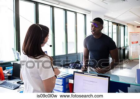 Nurse speaking with patient at hospital reception View Large Photo Image Stock Photo - Nurse speaking with patient at hospital reception. Fotosearch