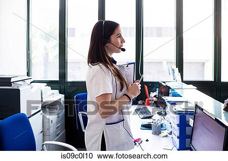 Nurse waiting at hospital reception View Large Photo Image Stock Image - Nurse waiting at hospital reception. Fotosearch