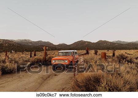 Stock Photo - Off road vehicle going through landscape of Kennedy Meadows, California, US. Fotosearch