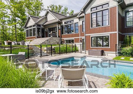 Outdoor swimming pool by luxury house, Quebec, Canada View Large Photo Image Stock Photo - Outdoor swimming pool by luxury house, Quebec, Canada. Fotosearch