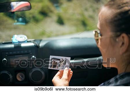 Over shoulder view of young woman on road trip holding instant photograph with boyfriend, Breckenridge, Colorado, USA View Large Photo Image Stock Image - Over shoulder view of young woman on road trip holding instant photograph with boyfriend, Breckenridge, Colorado, USA. Fotosearch
