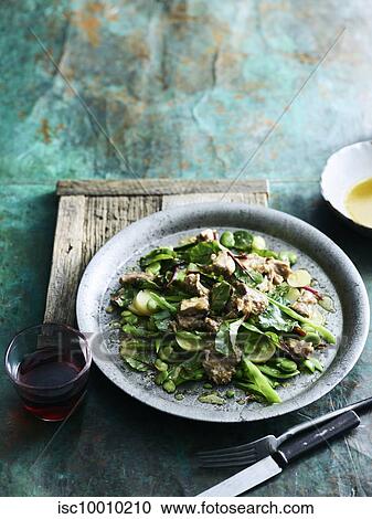 Stock Image - Oxtail and spring vegetable salad. Fotosearch