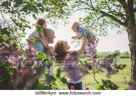 Parents and children playing in park View Large Photo Image Picture - Parents and children playing in park. Fotosearch