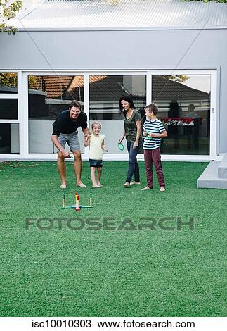 Parents and children playing ring toss on lawn View Large Photo Image Stock Image - Parents and children playing ring toss on lawn. Fotosearch
