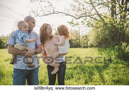 Parents and children taking walk in park View Large Photo Image Stock Photography - Parents and children taking walk in park. Fotosearch
