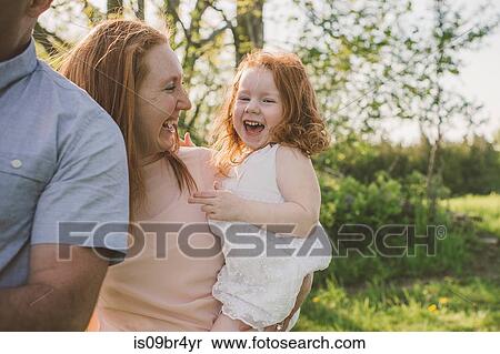 Parents and daughter taking walk in park View Large Photo Image Stock Photography - Parents and daughter taking walk in park. Fotosearch