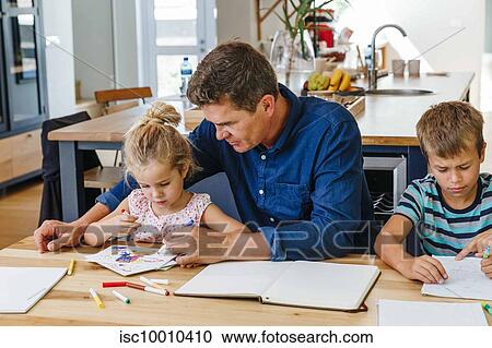 Parents helping children with homework at home View Large Photo Image Stock Image - Parents helping children with homework at home. Fotosearch
