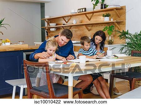 Parents helping children with homework at home View Large Photo Image Stock Image - Parents helping children with homework at home. Fotosearch