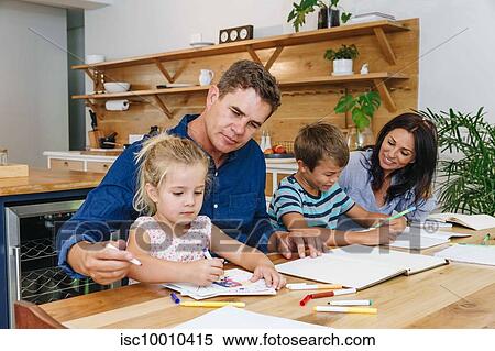 Parents helping children with homework at home View Large Photo Image Stock Photography - Parents helping children with homework at home. Fotosearch