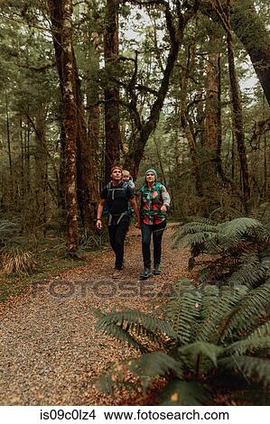 Picture - Parents with baby exploring forest, Queenstown, Canterbury, New Zealand. Fotosearch