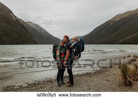 Stock Photography - Parents with baby on beach, Queenstown, Canterbury, New Zealand. Fotosearch