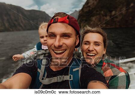 Stock Image - Parents with baby on lake cruise, Queenstown, Canterbury, New Zealand. Fotosearch