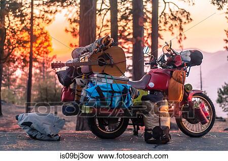 Part unloaded touring motorcycle parked on forest roadside at sunset, Yosemite National Park, California, USA View Large Photo Image Stock Photo - Part unloaded touring motorcycle parked on forest roadside at sunset, Yosemite National Park, California, USA. Fotosearch