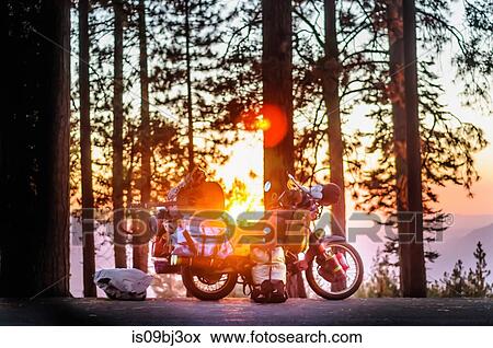 Part unloaded touring motorcycle parked on forest roadside at sunset, Yosemite National Park, California, USA View Large Photo Image Stock Photo - Part unloaded touring motorcycle parked on forest roadside at sunset, Yosemite National Park, California, USA. Fotosearch