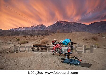 Part unloaded touring motorcycle parked at picnic area at sunset, High Sierra National Forest, California, USA View Large Photo Image Stock Photograph - Part unloaded touring motorcycle parked at picnic area at sunset, High Sierra National Forest, California, USA. Fotosearch