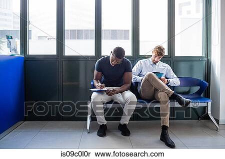 Patients completing forms at hospital reception View Large Photo Image Stock Photography - Patients completing forms at hospital reception. Fotosearch