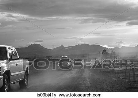 Pick-up and cars on dusty dirt track at dusk, B&W, Browning, Montana, USA View Large Photo Image Stock Photo - Pick-up and cars on dusty dirt track at dusk, B&W, Browning, Montana, USA. Fotosearch