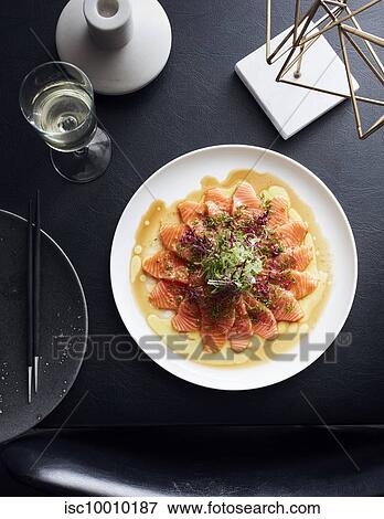 Plate of salmon slices served with white wine View Large Photo Image Stock Photo - Plate of salmon slices served with white wine. Fotosearch