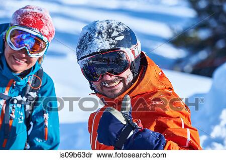 Stock Photography - Portrait of a male and female skier in helmet and goggles on ski slope, Aspen, Colorado, USA. Fotosearch