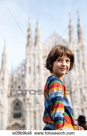 Portrait of boy looking over his shoulder in Milan Cathedral square, Milan, Lombardy, Italy View Large Photo Image Stock Photograph - Portrait of boy looking over his shoulder in Milan Cathedral square, Milan, Lombardy, Italy. Fotosearch