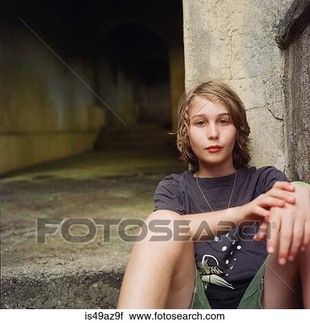 Portrait of boy, sitting in urban setting View Large Photo Image Stock Image - Portrait of boy, sitting in urban setting. Fotosearch