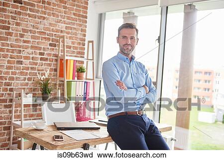 Portrait of businessman arms folded looking at camera View Large Photo Image Stock Image - Portrait of businessman arms folded looking at camera. Fotosearch