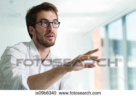Portrait of businessman, hand raised in conversation View Large Photo Image Stock Image - Portrait of businessman, hand raised in conversation. Fotosearch