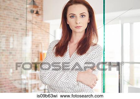 Portrait of businesswoman arms folded looking at camera View Large Photo Image Stock Image - Portrait of businesswoman arms folded looking at camera. Fotosearch