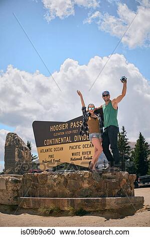 Stock Image - Portrait of couple by Continental Divide sign, Breckenridge, Colorado, USA. Fotosearch