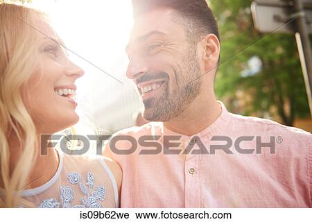 Portrait of couple in sunlight face to face smiling View Large Photo Image Stock Image - Portrait of couple in sunlight face to face smiling. Fotosearch
