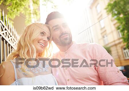 Portrait of couple in sunlight looking away smiling View Large Photo Image Stock Image - Portrait of couple in sunlight looking away smiling. Fotosearch