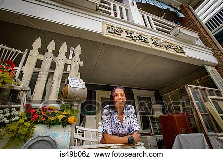 Portrait of female shop keeper at front porch shabby chic shop View Large Photo Image Stock Photo - Portrait of female shop keeper at front porch shabby chic shop. Fotosearch