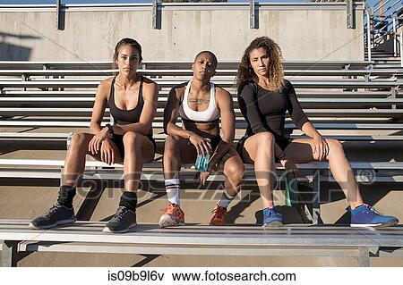 Portrait of friends sitting on benches looking at camera View Large Photo Image Stock Photo - Portrait of friends sitting on benches looking at camera. Fotosearch
