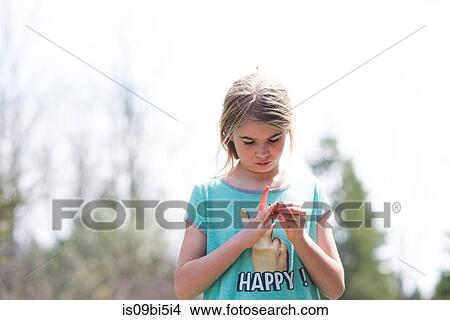 Portrait of girl looking down at fingers View Large Photo Image Picture - Portrait of girl looking down at fingers. Fotosearch