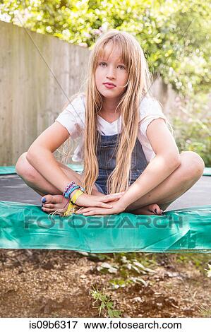 Portrait of girl sitting on trampoline looking at camera View Large Photo Image Stock Photo - Portrait of girl sitting on trampoline looking at camera. Fotosearch
