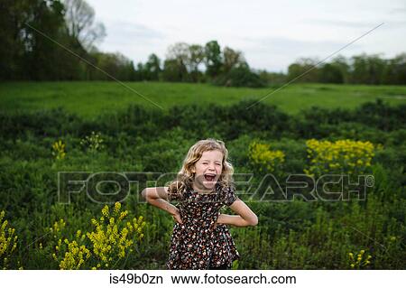 Portrait of girl with wavy blond hair laughing in field View Large Photo Image Picture - Portrait of girl with wavy blond hair laughing in field. Fotosearch