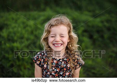 Portrait of girl with wavy blond hair and missing tooth in field View Large Photo Image Stock Photography - Portrait of girl with wavy blond hair and missing tooth in field. Fotosearch