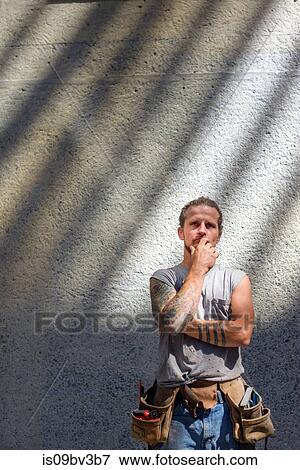 Portrait of handyman deep in thought View Large Photo Image Stock Photo - Portrait of handyman deep in thought. Fotosearch