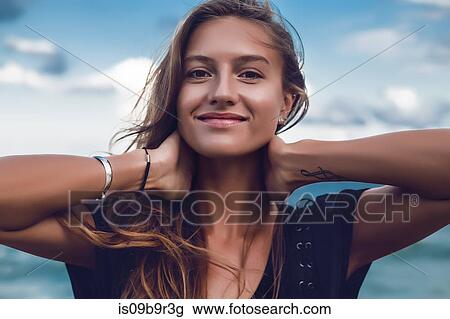 Stock Image - Portrait of happy young woman on beach, head and shoulders, Odessa, Odessa Oblast, Ukraine. Fotosearch