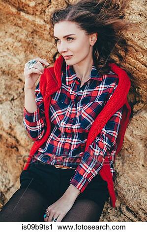 Stock Image - Portrait of mid adult woman leaning against beach cliff, Odessa Oblast, Ukraine. Fotosearch