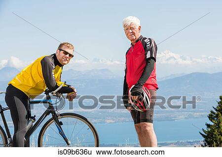 Portrait of senior man and grandson, wearing cycling clothes, standing on hill, Geneva, Switzerland, Europe View Large Photo Image Stock Photograph - Portrait of senior man and grandson, wearing cycling clothes, standing on hill, Geneva, Switzerland, Europe. Fotosearch