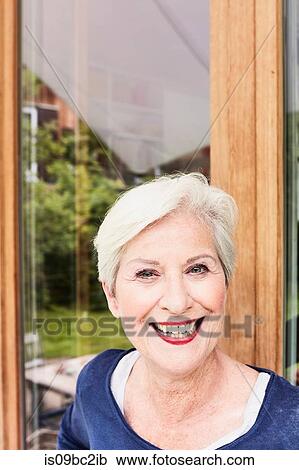 Stock Image - Portrait of senior woman, smiling. Fotosearch