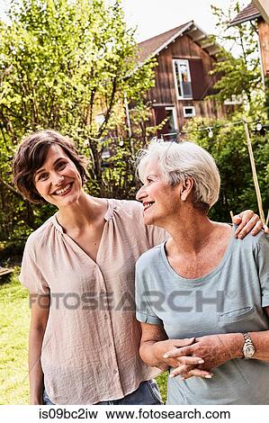 Portrait of senior woman with grown daughter, outdoors, smiling View Large Photo Image Stock Photo - Portrait of senior woman with grown daughter, outdoors, smiling. Fotosearch